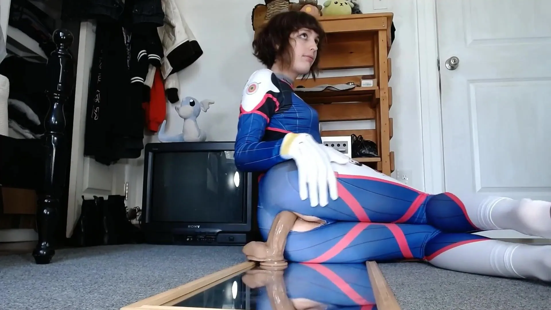 Teenage femboy in D.Va costume play opens up and fake penises his donk